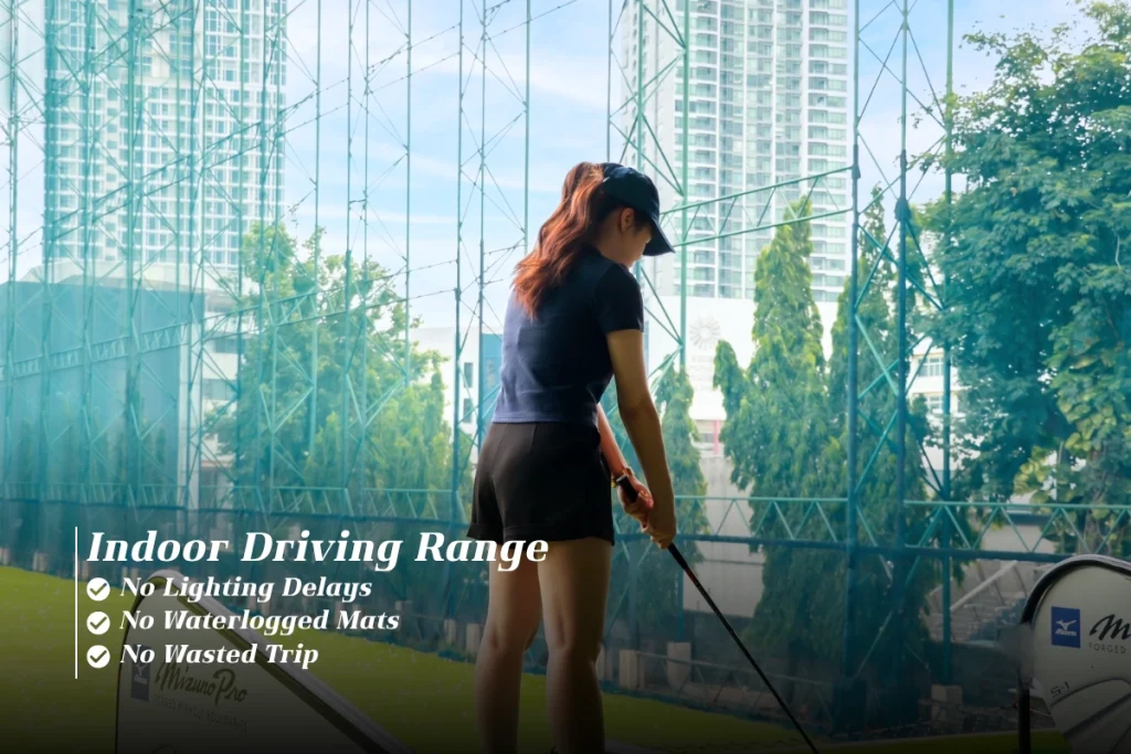 Golfer practising indoors at a Bangkok driving range 