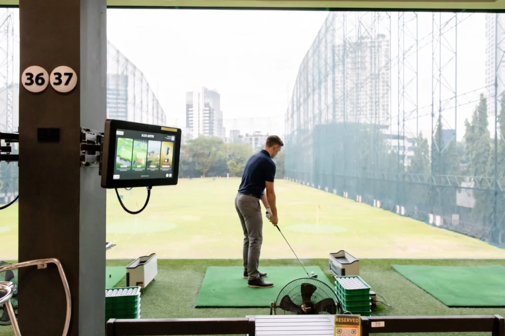 Golfer taking a lesson at 42 TEE-OFF range, Sukhumvit, Bangkok